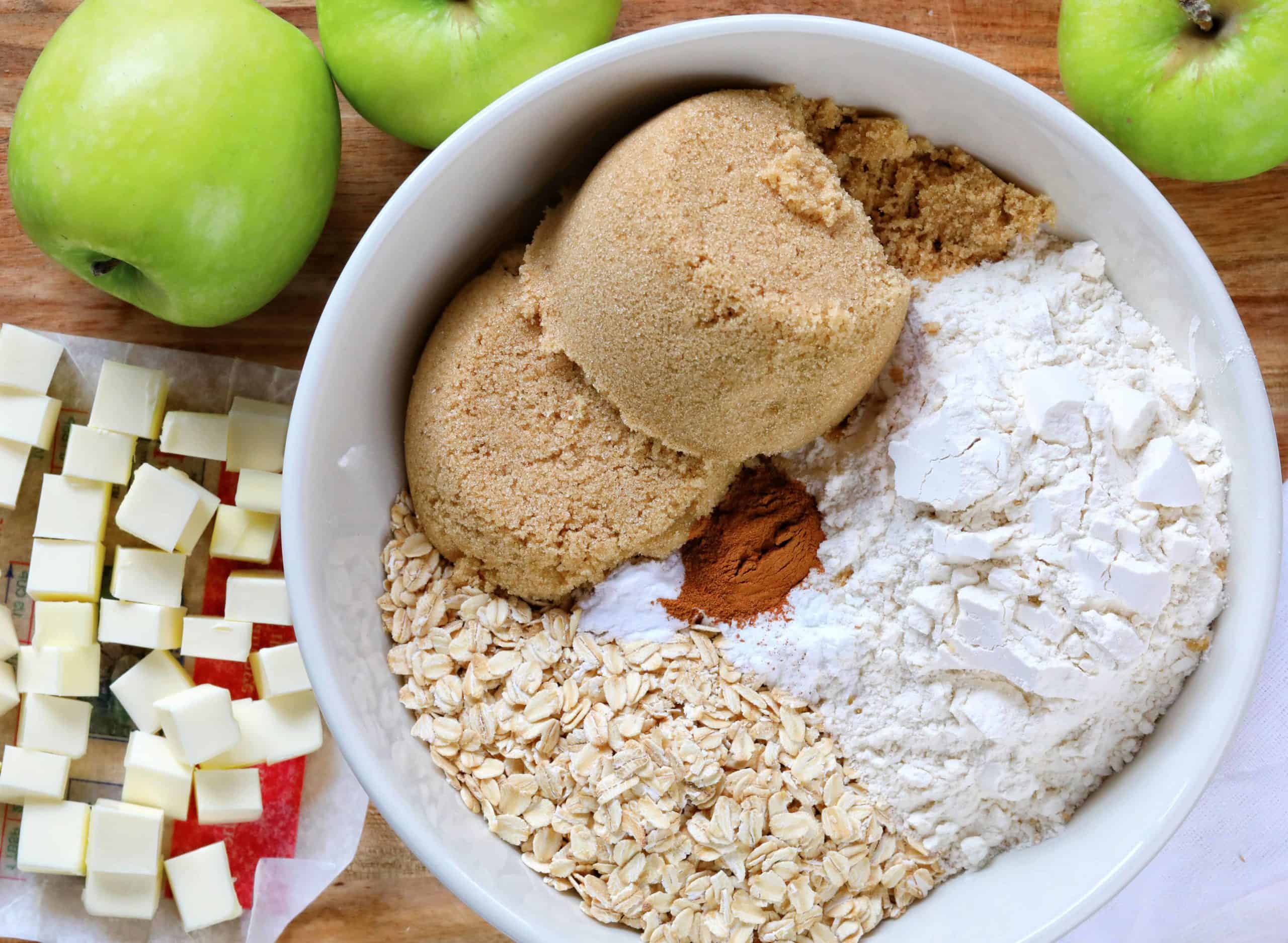 This is the only Apple Crisp recipe you will ever need!! HUGE flavor! Apple Crisp, Apple Crumble, perfect apple crisp, how to make apple crisp, easy apple crisp, i am baker, best apple crisp, easy apple crisp, award wining apple crisp, i am baker, iambaker, apple crumble recipe How to Make Apple Crisp, Raw Ingredients in Bowl and on Cutting Board.