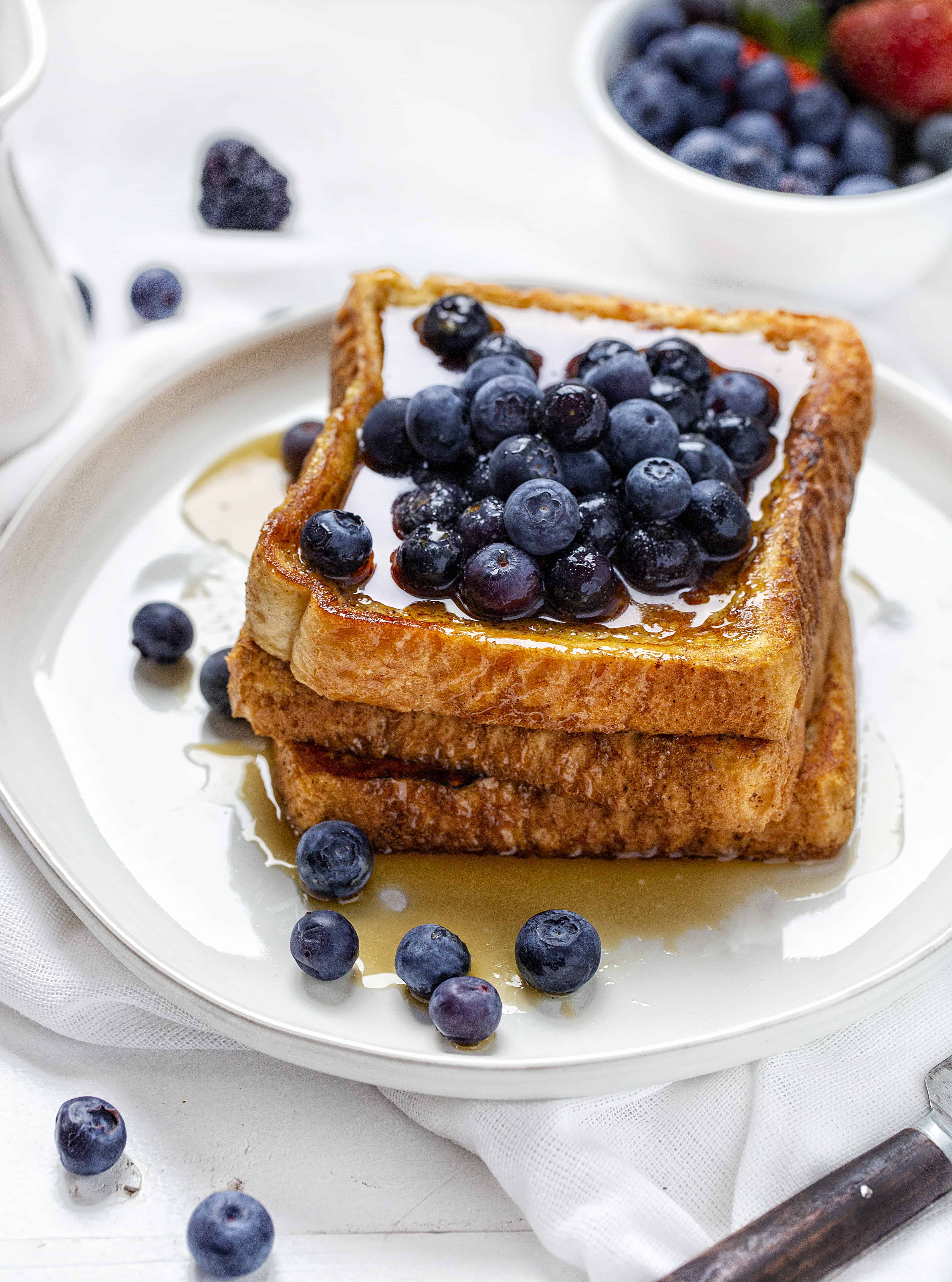 This is the recipe that won't fail you! Perfect flavor and consistency, every time! french toast, easy french toast, how to make french toast, french toast recipe, iambaker No-Fail French Toast Stacked and Covered in Blueberries.