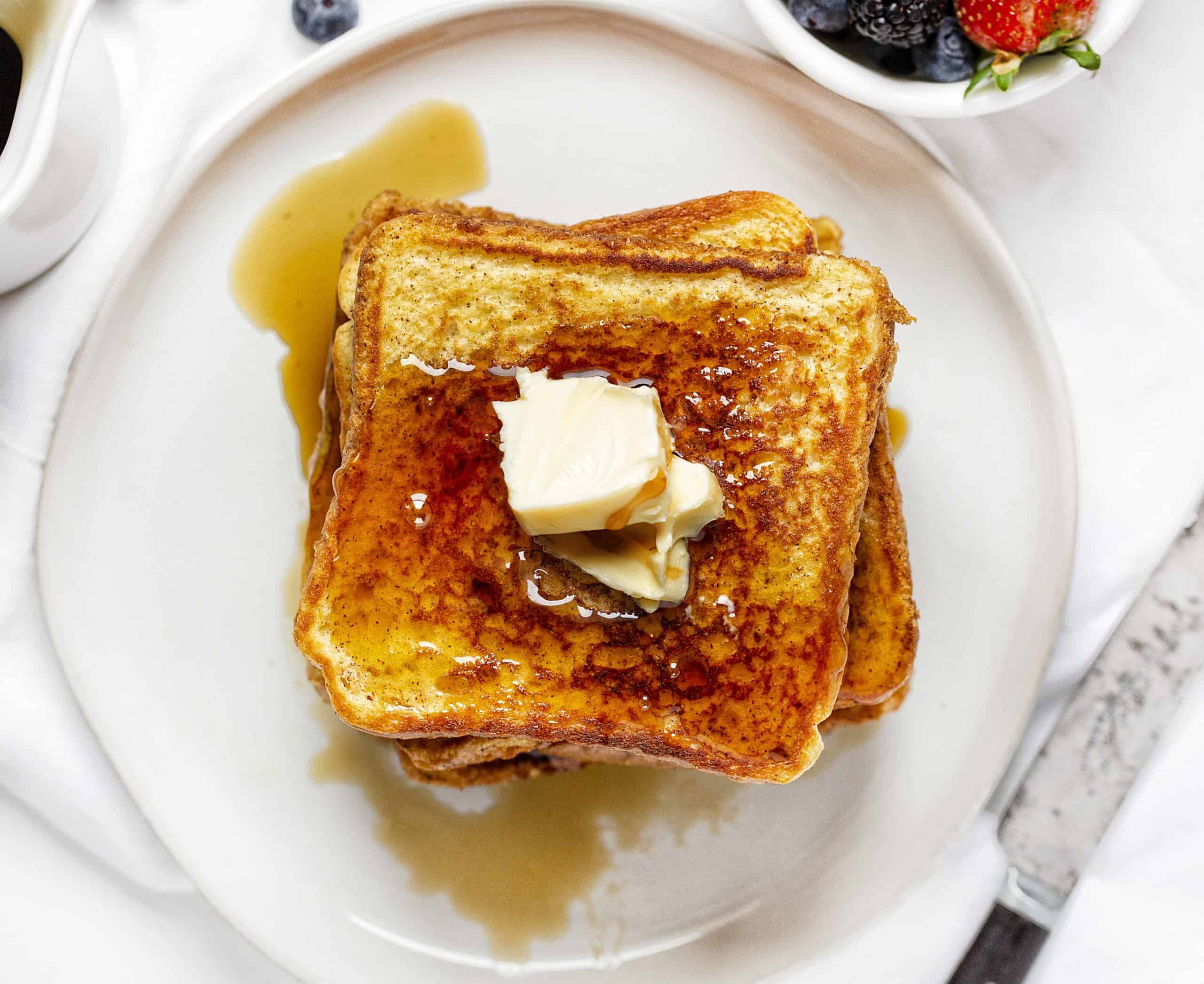 This is the recipe that won't fail you! Perfect flavor and consistency, every time! french toast, easy french toast, how to make french toast, french toast recipe, iambaker Plate of French Toast Covered in Syrup and Butter.