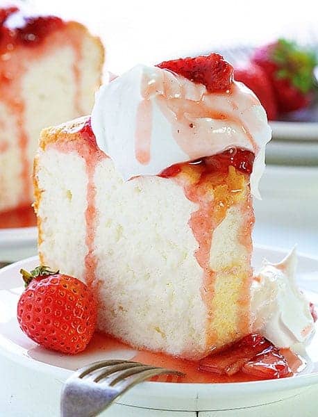 The BEST Angel Food Cake you will ever make!! SO MUCH BETTER than store bought and always a crowd pleaser! #angelfood #angelfoodcake #roastedstrawberries #angelfoodcakerecipe #iambaker #summerdesserts Angel Food Cake with Roasted Strawberry Sauce