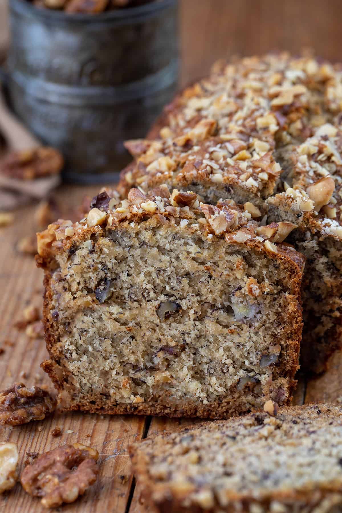 Browned Butter Banana Nut Bread is made by browning butter to add a toasty taste and then loading and topping the bread with chopped walnuts to add even more nutty flavor. It is definitely a step up from traditional banana bread and possibly my new favorite way to enjoy it! (If you prefer a recipe without nuts, I also have my Best Banana Bread Recipe you will want to try.) Cut Into Brown Butter Banana Nut Bread With Pieces Fallen and Focus on Piece still Near the Loaf.