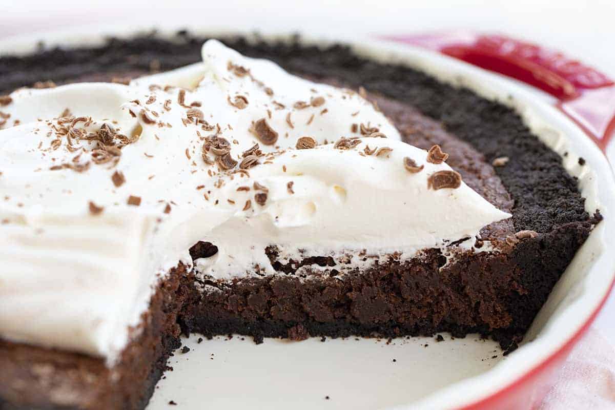 Brownie Pie is a dessert made with an Oreo cookie crust, a layer of chewy brownies, and topped with homemade whipped topping with a drizzle of chocolate syrup. Brownie Pie, How to Make Brownie Pie, the Original Brownie Pie, Brownie Recipe, Pie, Dessert, recipes, baking, i am baker, iambaker Cut Into Brownie Pie Recipe