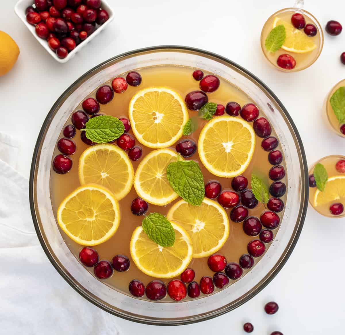 Christmas Punch is a festive and fizzy alcoholic beverage made with orange juice, pineapple juice, cranberry juice, lemon juice, triple sec, rum, and lemon-lime soda. Boozy Punch, Alcohol in Punch, Recipe for Holiday Punch, holiday drink recipes, i am baker, iambaker Overhead image of Fruity Christmas Punch