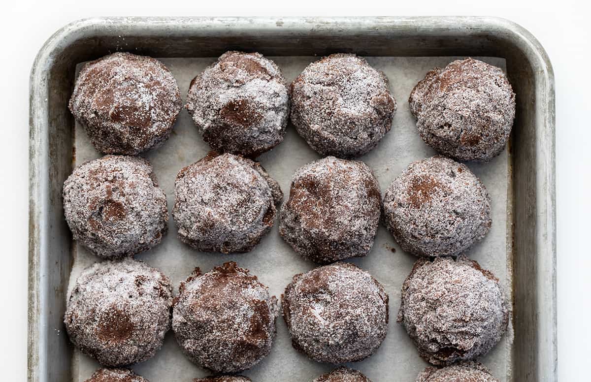 Dirty Chocolate Cookies are rich chocolate cookies rolled in sugar with a crispy outside and a soft, chewy center. Using two kinds of chocolate in the cookies makes them a decadent and indulgent treat with a deep chocolate flavor in every bite. They are worth the crumbs and sugar that may get everywhere! Raw Dirty Chocolate Cookie Batter Before Baking on a Cookie Sheet.