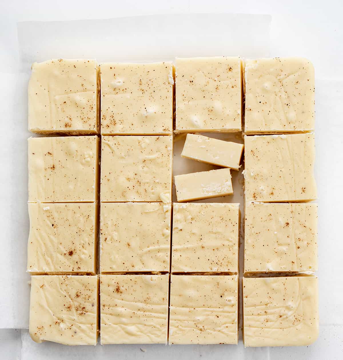 Eggnog Fudge Once you see how easy this eggnog fudge recipe is, you will want to make other varieties! And, with eggnog as one of the main ingredients, it’s a must for your New Year’s Eve celebrations. In addition, with the popularity of Christmas dessert charcuterie boards, pieces of this fudge would be a perfect addition to the board! Eggnog Fudge but into squares.