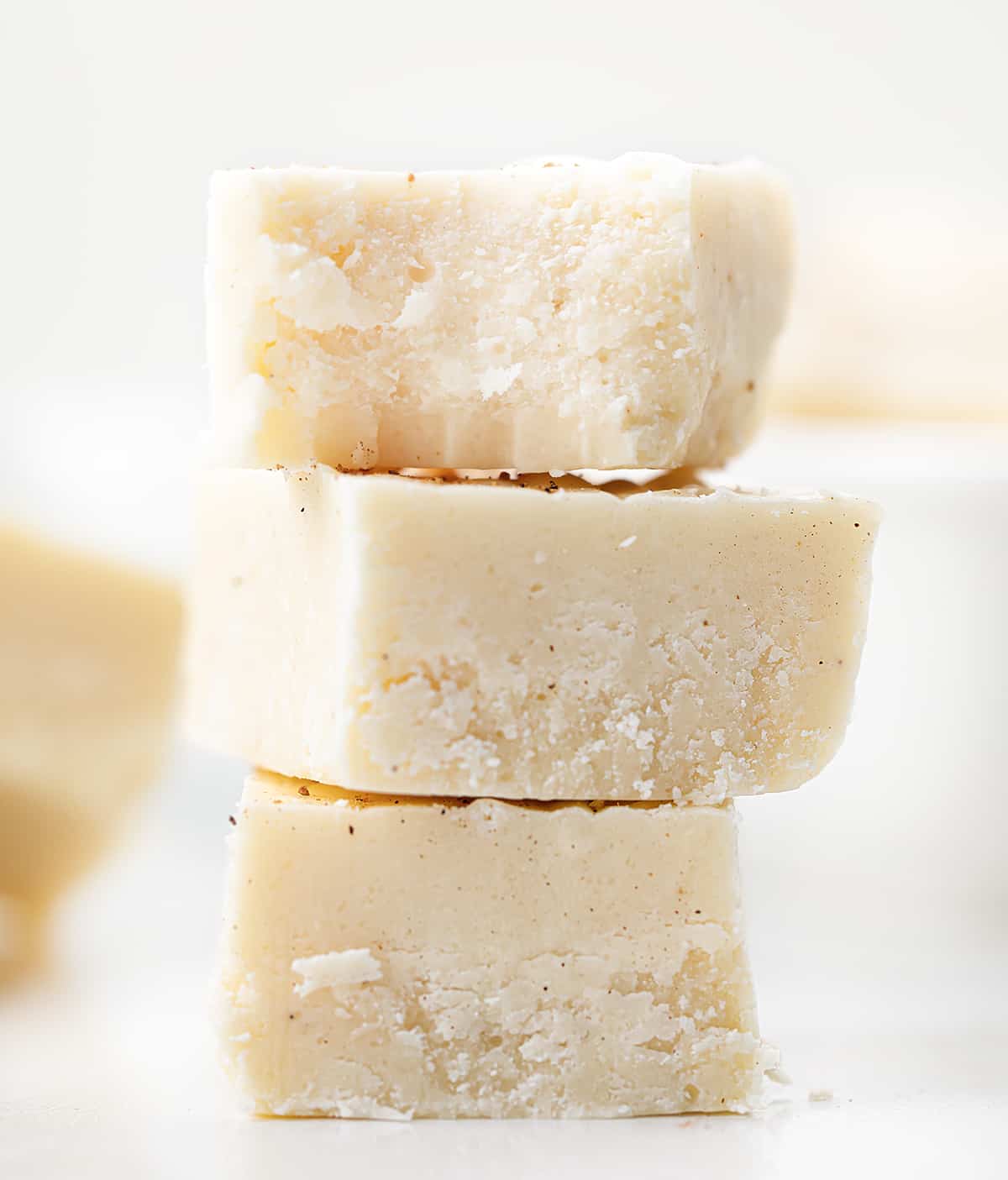 Eggnog Fudge Once you see how easy this eggnog fudge recipe is, you will want to make other varieties! And, with eggnog as one of the main ingredients, it’s a must for your New Year’s Eve celebrations. In addition, with the popularity of Christmas dessert charcuterie boards, pieces of this fudge would be a perfect addition to the board! Stack of Pieces of Eggnog Fudge.