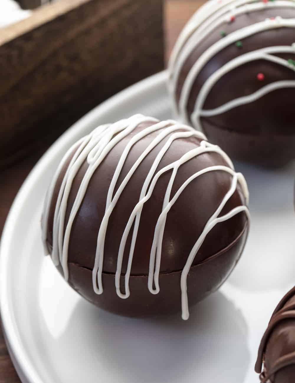 These tried and true top ten recipes from January 2021 have you covered from main dishes, to sweet treats, to desserts! i am baker, iambaker, hot chocolate bombs, hot chocolate, decorating desserts, hot cocoa bombs, hot cocoa Hot Chocolate Bombs on White Platter