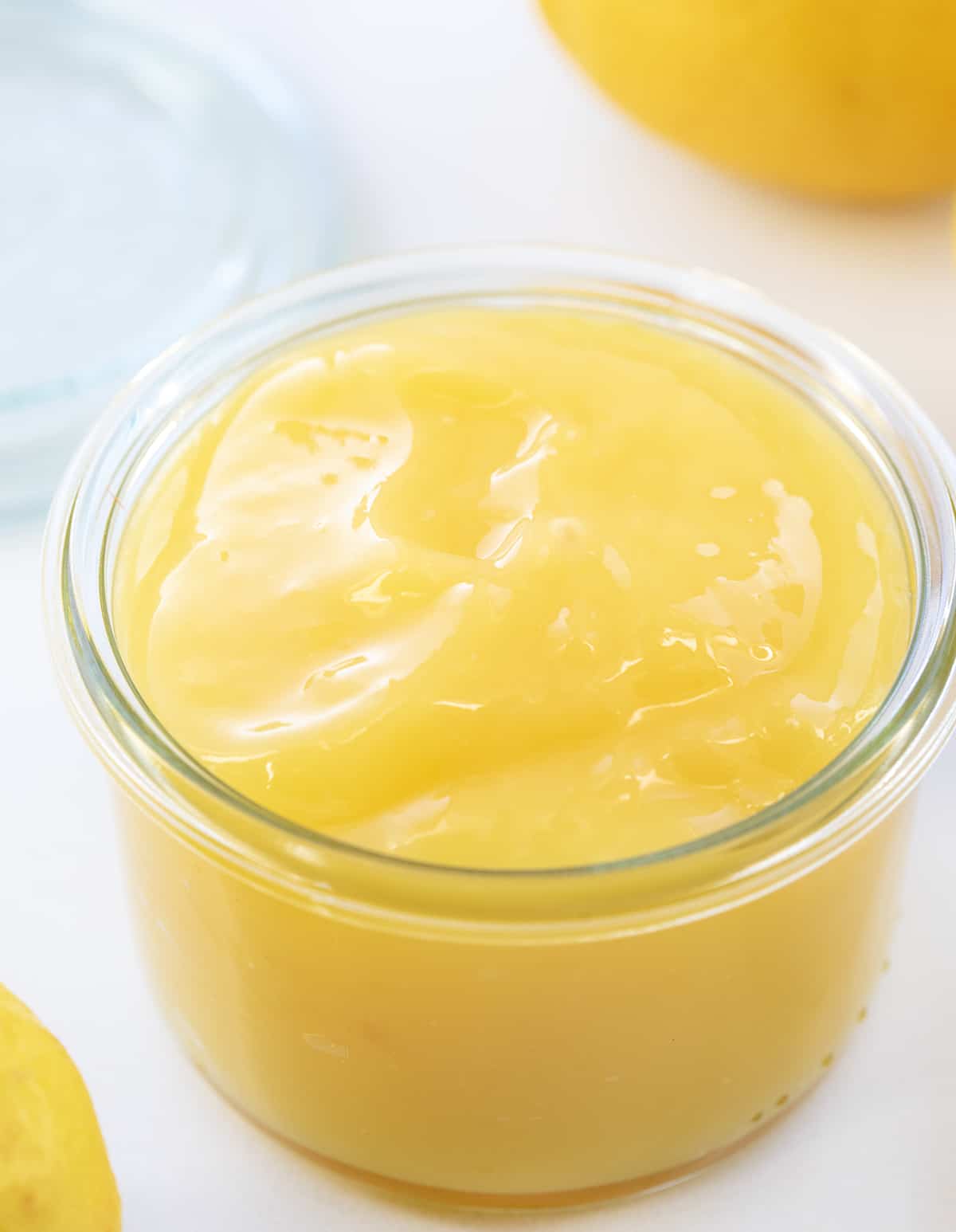 Homemade Lemon Curd is a tart and lemony spread, filling, or topping made from a few simple ingredients. It has a thick and creamy consistency that adds a burst of citrus flavor to many treats and desserts! Jar of Fresh Lemon Curd.