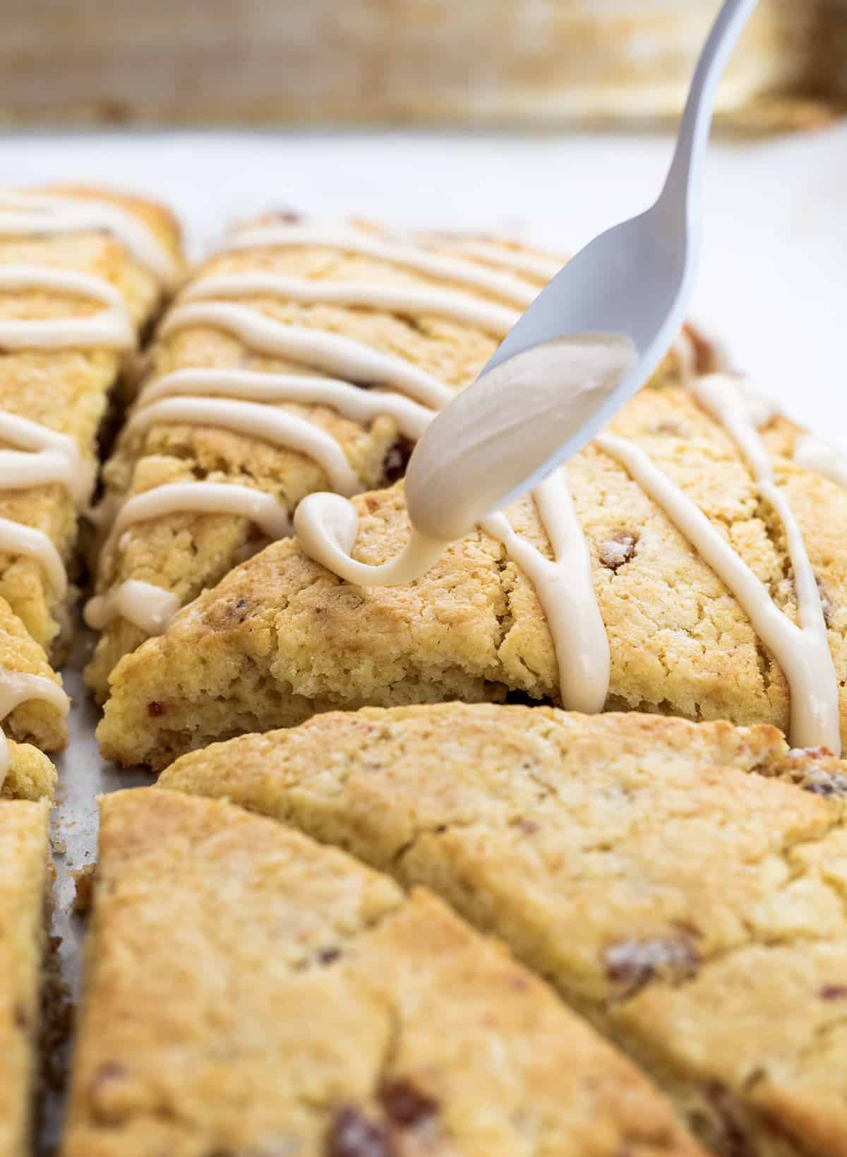 Drizzling Maple Glaze over Maple Bacon Scones.
