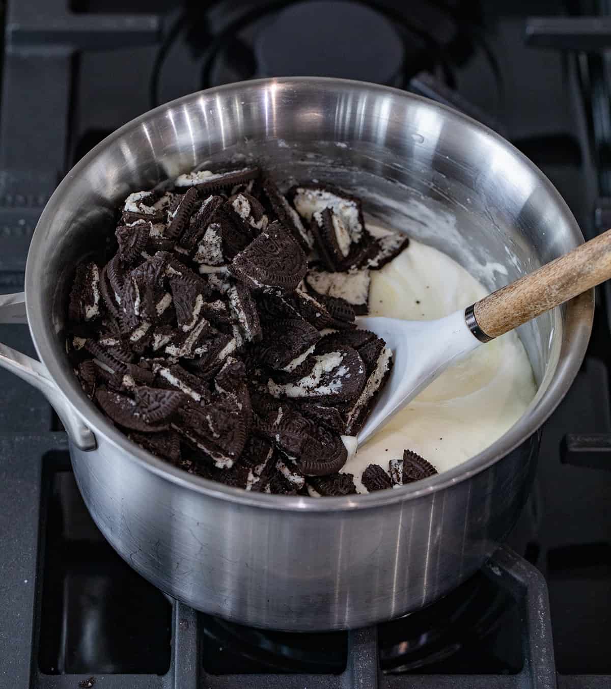 Cookies and Cream Fudge is an easy-to-make treat with white chocolate chips, marshmallow fluff, and Oreo cookies. It should definitely be added to your list of holiday treats this season! Ingredients for Making Cookies and Cream Fudge in a Pan Before Stirring.