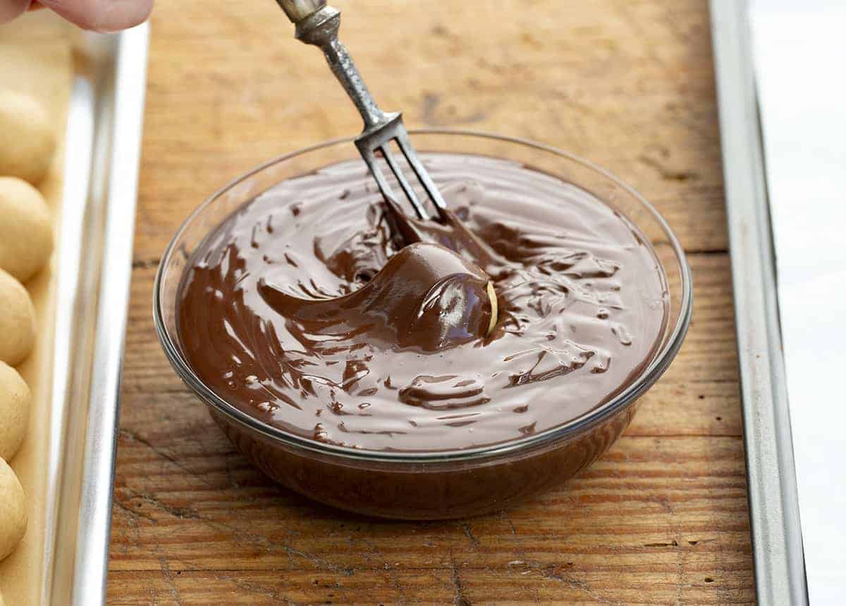 Peanut Butter Balls are sweet treats that are made with creamy peanut butter and coated with a layer of melted, semi-sweet chocolate. PeanutButter Balls, PB Balls recipes, Christmas Candy, Candy, recipes, Peanut Butter Balls Recipes, How to Make PB Candy, iambaker, i am baker Dipping Peanut Butter Balls into Chocolate