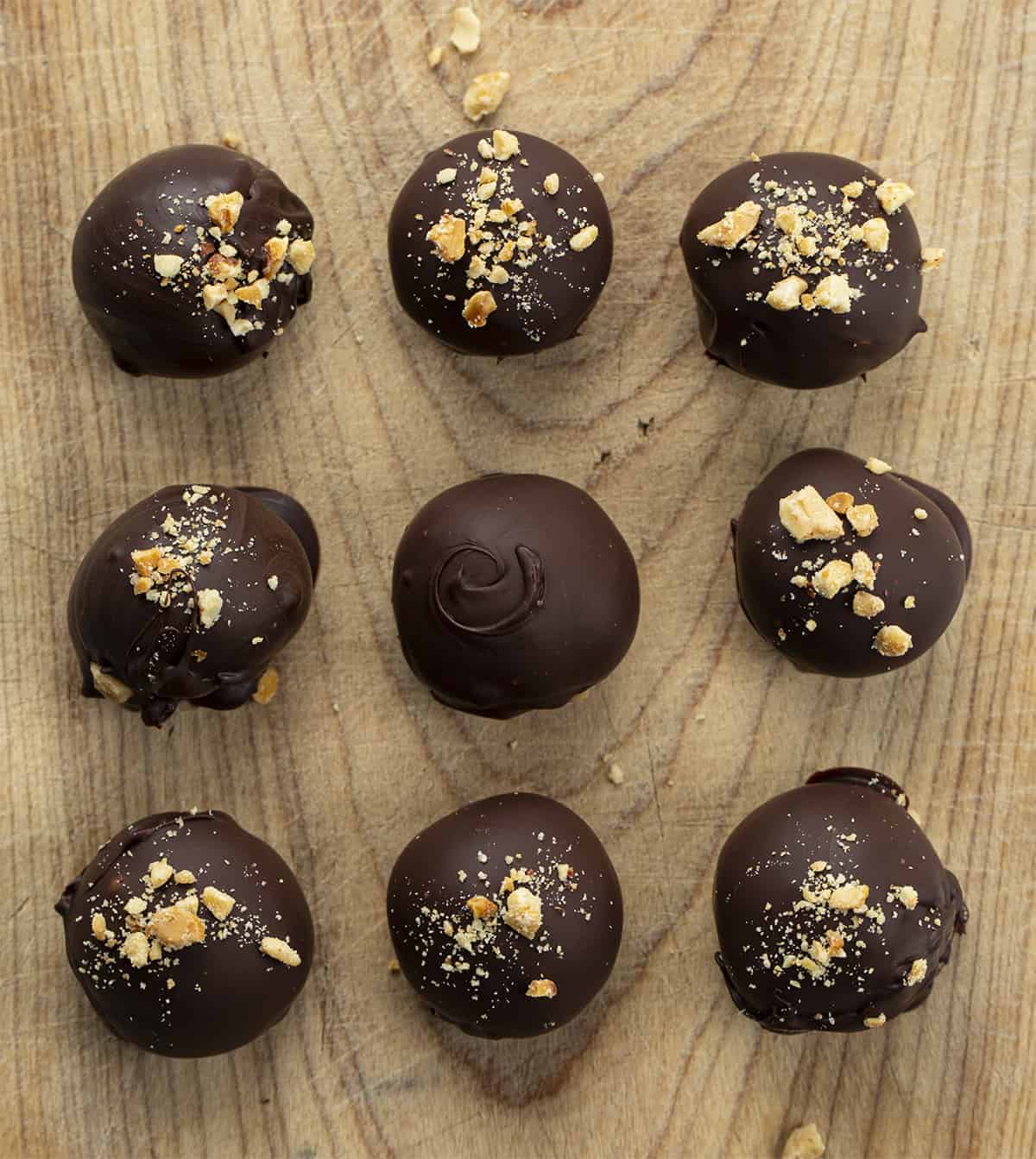 Peanut Butter Balls are sweet treats that are made with creamy peanut butter and coated with a layer of melted, semi-sweet chocolate. PeanutButter Balls, PB Balls recipes, Christmas Candy, Candy, recipes, Peanut Butter Balls Recipes, How to Make PB Candy, iambaker, i am baker Peanut Butter Balls on a Cutting Board