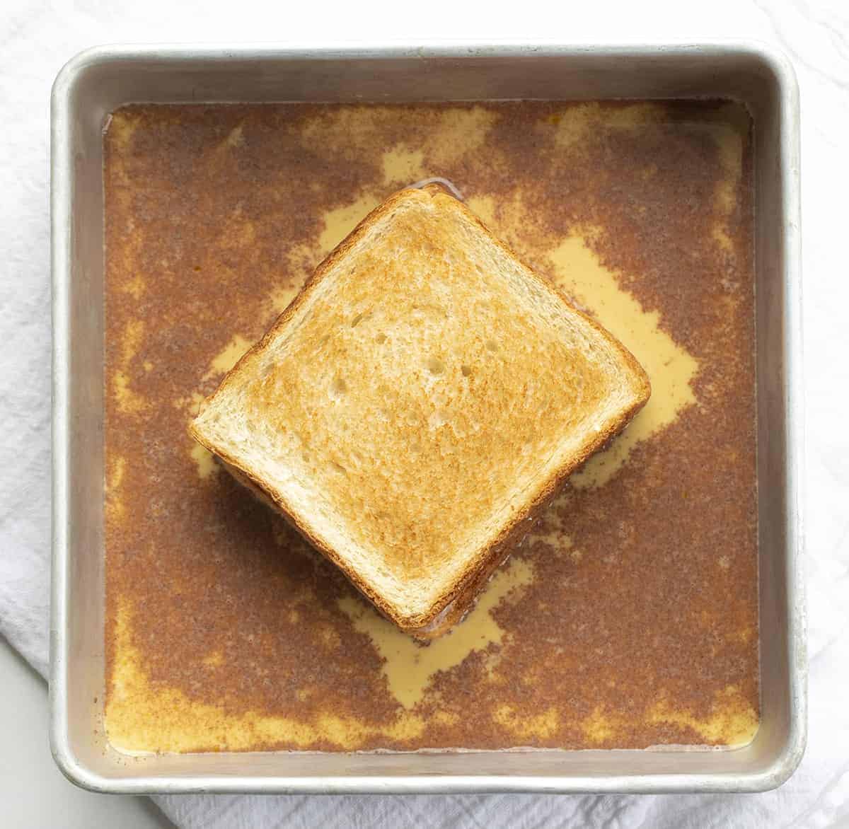 Stuffed French Toast is covered with a cinnamon and sugar coating and filled with cream cheese and juicy strawberries, topped with confectioners’ sugar and whipped cream. Stuffed French Toast, How to Make Stuffed French Toast, Stuffed French Toast Recipe, Breakfast, French Toast, Recipes, i am baker, iambaker Adding Stuffed French Toast to Egg Mixture