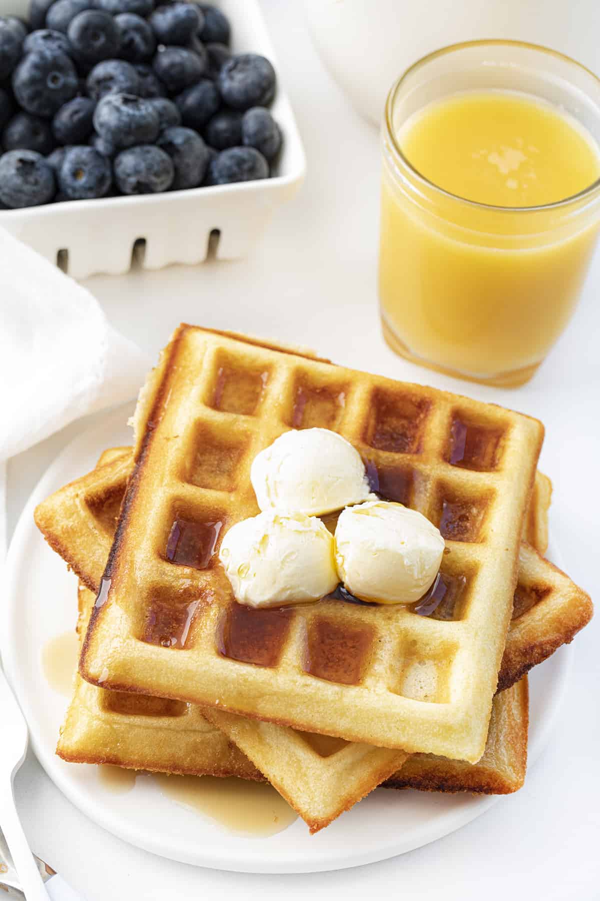 Waffles of Insane Greatness are waffles that are made from a copycat of Aretha Frankenstein's popular waffle mix. Waffles, Waffle REcipes, Breakfast, Breakfast Recipes, How to Make Waffles, The Best Waffles, i am baker, iambaker, recipes Waffles of Insane Greatness on Plate with Fruit and Butter